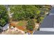 Aerial view of a large backyard featuring a shed, partial fence, and mature trees at 1725 E Honey Springs Ave, Fuquay Varina, NC 27526