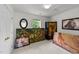 Bright bedroom with white walls, a window with green outside, and artwork and screen around the room at 1725 E Honey Springs Ave, Fuquay Varina, NC 27526