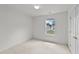 Neutral toned bedroom with white walls, a window overlooking the neighborhood, and a double door closet at 1725 E Honey Springs Ave, Fuquay Varina, NC 27526