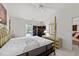 Bedroom featuring a four-poster bed, white walls, and modern furnishings with natural light at 1725 E Honey Springs Ave, Fuquay Varina, NC 27526