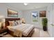 Comfortable bedroom with neutral decor, a large window, and natural light at 1725 E Honey Springs Ave, Fuquay Varina, NC 27526