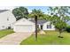 Charming single-Gathering home with attached garage and manicured front lawn featuring mature palm tree at 1725 E Honey Springs Ave, Fuquay Varina, NC 27526