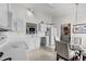 Bright kitchen boasts white cabinets, ample counter space, and a view into a nearby dining area at 1725 E Honey Springs Ave, Fuquay Varina, NC 27526