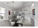 Eat-in kitchen features white cabinetry, a round glass table with seating, and bright natural lighting at 1725 E Honey Springs Ave, Fuquay Varina, NC 27526