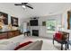 Inviting living room with a fireplace, ceiling fan, mounted television and an eclectic collection of decor at 1725 E Honey Springs Ave, Fuquay Varina, NC 27526