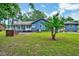 Expansive backyard with a screened-in porch and a brick patio, surrounded by mature trees at 1732 Farmington Rd, Rocky Mount, NC 27801