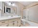 Cozy bathroom featuring wallpaper, a shower and bathtub, and a single-sink vanity at 1732 Farmington Rd, Rocky Mount, NC 27801