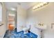 Bathroom features blue tile flooring and white fixtures with a pedestal sink and ample lighting at 1732 Farmington Rd, Rocky Mount, NC 27801