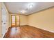 Bedroom with hardwood floors, classic trim, and a glass paneled exterior door at 1732 Farmington Rd, Rocky Mount, NC 27801