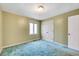 Simple bedroom with blue carpet, green walls, and a window providing natural light at 1732 Farmington Rd, Rocky Mount, NC 27801