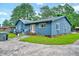 View of blue home's exterior showcasing the lawn and driveway at 1732 Farmington Rd, Rocky Mount, NC 27801
