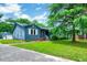 Quaint blue home with a well-manicured lawn and a charming red front door at 1732 Farmington Rd, Rocky Mount, NC 27801