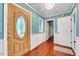 Bright foyer with hardwood floors, a decorative front door, and wainscoting at 1732 Farmington Rd, Rocky Mount, NC 27801