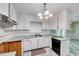 Traditional kitchen featuring white cabinets, blue countertops, and checkered flooring at 1732 Farmington Rd, Rocky Mount, NC 27801