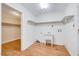Well-lit laundry room features a utility sink, shelving, and wood-look flooring at 1732 Farmington Rd, Rocky Mount, NC 27801