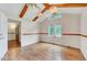 Light-filled living room with wood beams, wood-look floors, and large windows at 1732 Farmington Rd, Rocky Mount, NC 27801