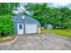 Exterior view of outbuilding and driveway, surrounded by lush greenery at 1732 Farmington Rd, Rocky Mount, NC 27801