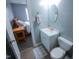 Bathroom with vanity and mirror with a bedroom in the background at 1806 Stroll Cir, Fuquay Varina, NC 27526