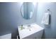 This bathroom features a white vanity, oval mirror, and a neutral color scheme that creates a serene atmosphere at 1806 Stroll Cir, Fuquay Varina, NC 27526