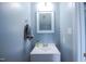 Modern bathroom features a sleek white vanity and a decorative framed mirror above at 1806 Stroll Cir, Fuquay Varina, NC 27526