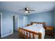 Spacious bedroom featuring a unique log bed frame, complemented by matching nightstands, a ceiling fan, and 2 doors at 1806 Stroll Cir, Fuquay Varina, NC 27526