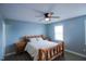 This bedroom features a unique log bed frame, complemented by matching nightstands and a modern ceiling fan at 1806 Stroll Cir, Fuquay Varina, NC 27526
