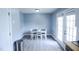 Bright dining area with grey wood floors and glass doors to the outside at 1806 Stroll Cir, Fuquay Varina, NC 27526