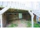 View of home's foundation, with access door and gravel surround at 1806 Stroll Cir, Fuquay Varina, NC 27526