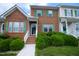 Charming brick townhome with green shutters and manicured front yard landscaping at 1806 Stroll Cir, Fuquay Varina, NC 27526