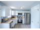Modern kitchen with stainless steel appliances, white cabinetry, and breakfast area at 1806 Stroll Cir, Fuquay Varina, NC 27526