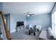 Bright living room with blue walls, modern furniture, and large windows at 1806 Stroll Cir, Fuquay Varina, NC 27526