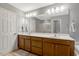 Bathroom features a double vanity with wood cabinets, a large mirror, and ample lighting fixtures at 201 Forbes Rd, Wake Forest, NC 27587