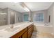 Bathroom with double vanity, tub, and glass block windows to provide privacy while letting natural light in at 201 Forbes Rd, Wake Forest, NC 27587