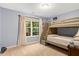 This bedroom features a bunk bed next to a window with white curtains and blue painted walls at 201 Forbes Rd, Wake Forest, NC 27587