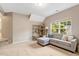 Spacious bonus room features a comfortable sofa and ample natural light, ideal for relaxation at 201 Forbes Rd, Wake Forest, NC 27587