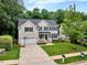 Two-story home with manicured lawn, two-car garage, blue shutters, and classic American curb appeal at 201 Forbes Rd, Wake Forest, NC 27587