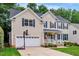 Inviting two-story home with a pristine lawn, two-car garage, and classic blue shutters at 201 Forbes Rd, Wake Forest, NC 27587