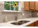 Modern kitchen detail showcases a stainless sink, gray subway tile backsplash, and quartz countertops at 201 Forbes Rd, Wake Forest, NC 27587