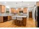 Beautiful kitchen featuring an island, pendant lights, stainless appliances, and wood floors at 201 Forbes Rd, Wake Forest, NC 27587