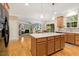 Open kitchen with island, wood floors, stainless appliances, seamlessly connected to the living area at 201 Forbes Rd, Wake Forest, NC 27587