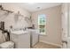 Functional laundry room with a washer, dryer, and storage shelves for convenience at 201 Forbes Rd, Wake Forest, NC 27587