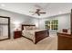 This is a bedroom with neutral paint, ceiling fan, a large window, and a dark wood furniture set at 201 Forbes Rd, Wake Forest, NC 27587