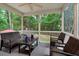 Relaxing screened porch with comfortable wicker furniture and views of the lush backyard at 201 Forbes Rd, Wake Forest, NC 27587