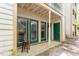 Outdoor back patio area with green door and views of surrounding foliage at 2010 Quaker Lndg # 102, Raleigh, NC 27603