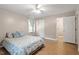 This nice bedroom is complete with hardwood floors, a ceiling fan, and ensuite bathroom access at 2010 Quaker Lndg # 102, Raleigh, NC 27603