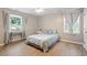 Cozy bedroom boasts hardwood floors, a ceiling fan, large window and ample natural light at 2010 Quaker Lndg # 102, Raleigh, NC 27603