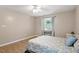 Comfortable bedroom has hardwood floors, a ceiling fan and nice windows for natural light at 2010 Quaker Lndg # 102, Raleigh, NC 27603