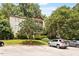 Multi-story condo complex with multiple balconies surrounded by lush landscaping at 2010 Quaker Lndg # 102, Raleigh, NC 27603