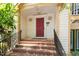 Exterior shot of front steps with brick and concrete combination leading to a red front door at 2010 Quaker Lndg # 102, Raleigh, NC 27603