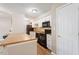 Kitchen with island, stainless appliances, and white cabinets offers a modern aesthetic at 2010 Quaker Lndg # 102, Raleigh, NC 27603